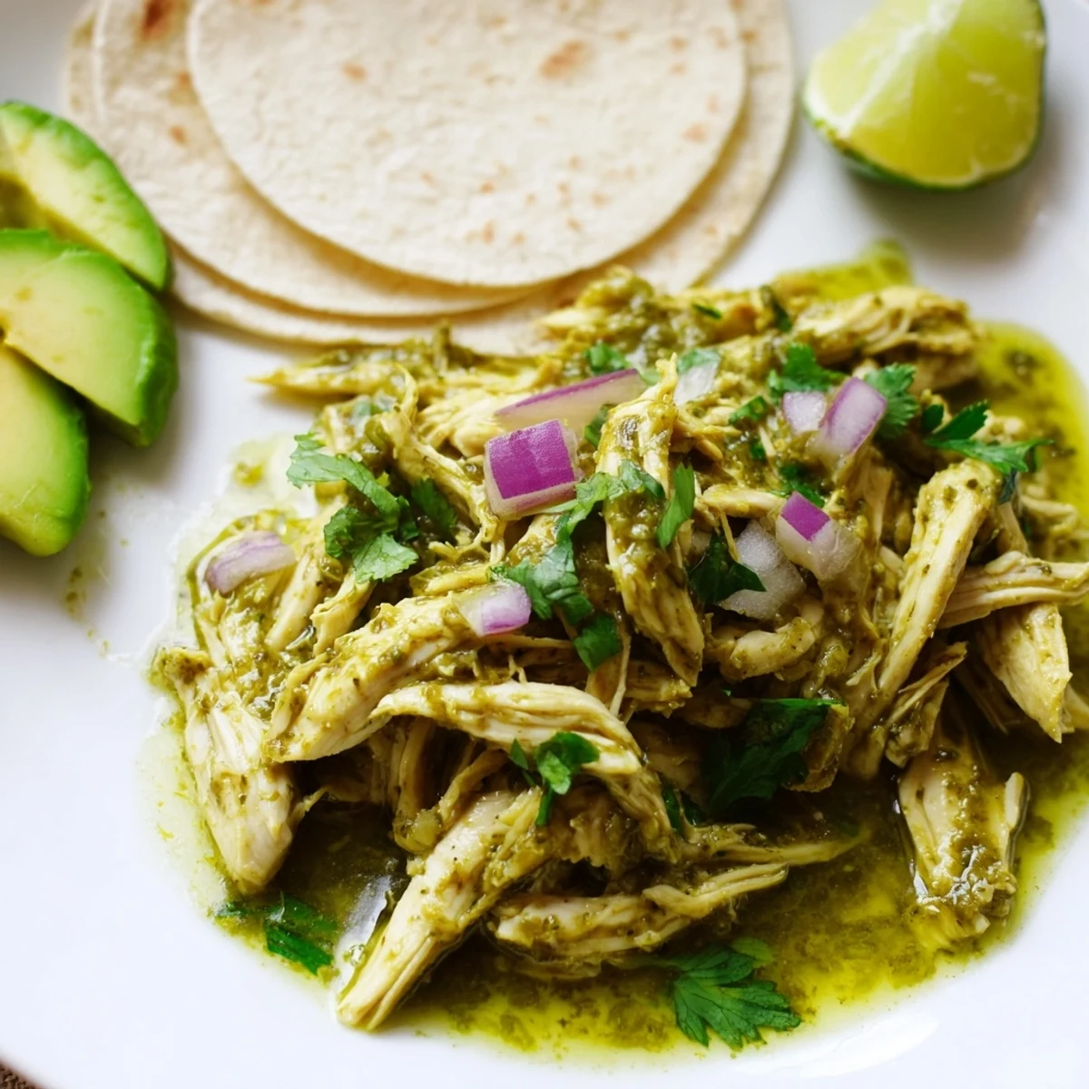 Zesty salsa verde chicken taco filling with cilantro and avocado ready for serving