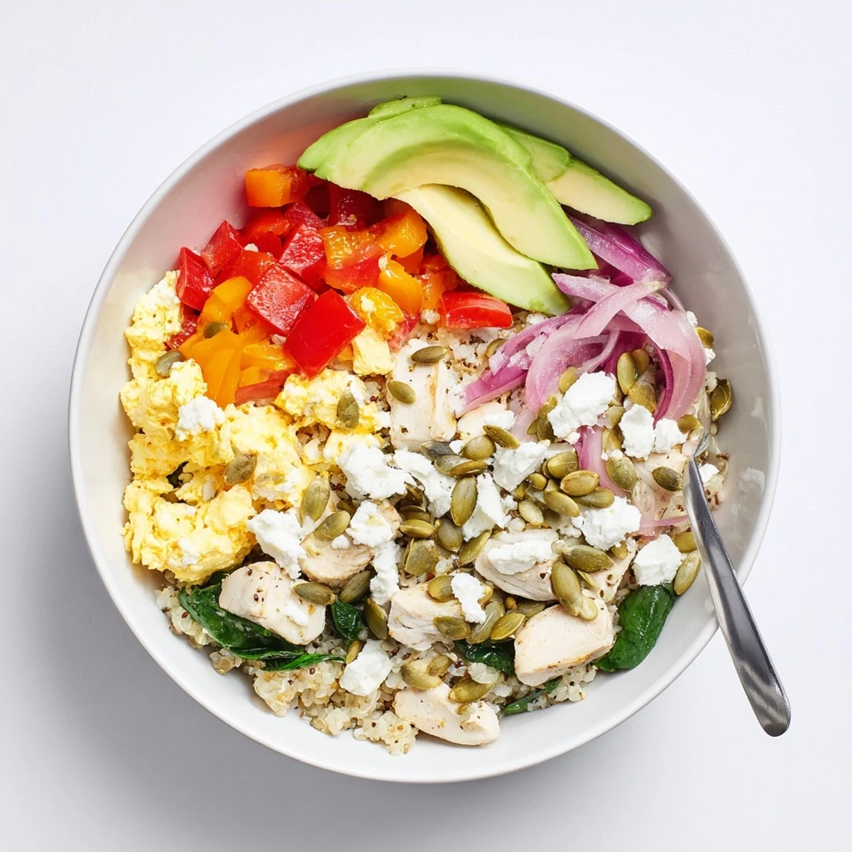Protein-packed Easy High Protein Breakfast Bowl layered with scrambled eggs, diced chicken, spinach, and feta cheese