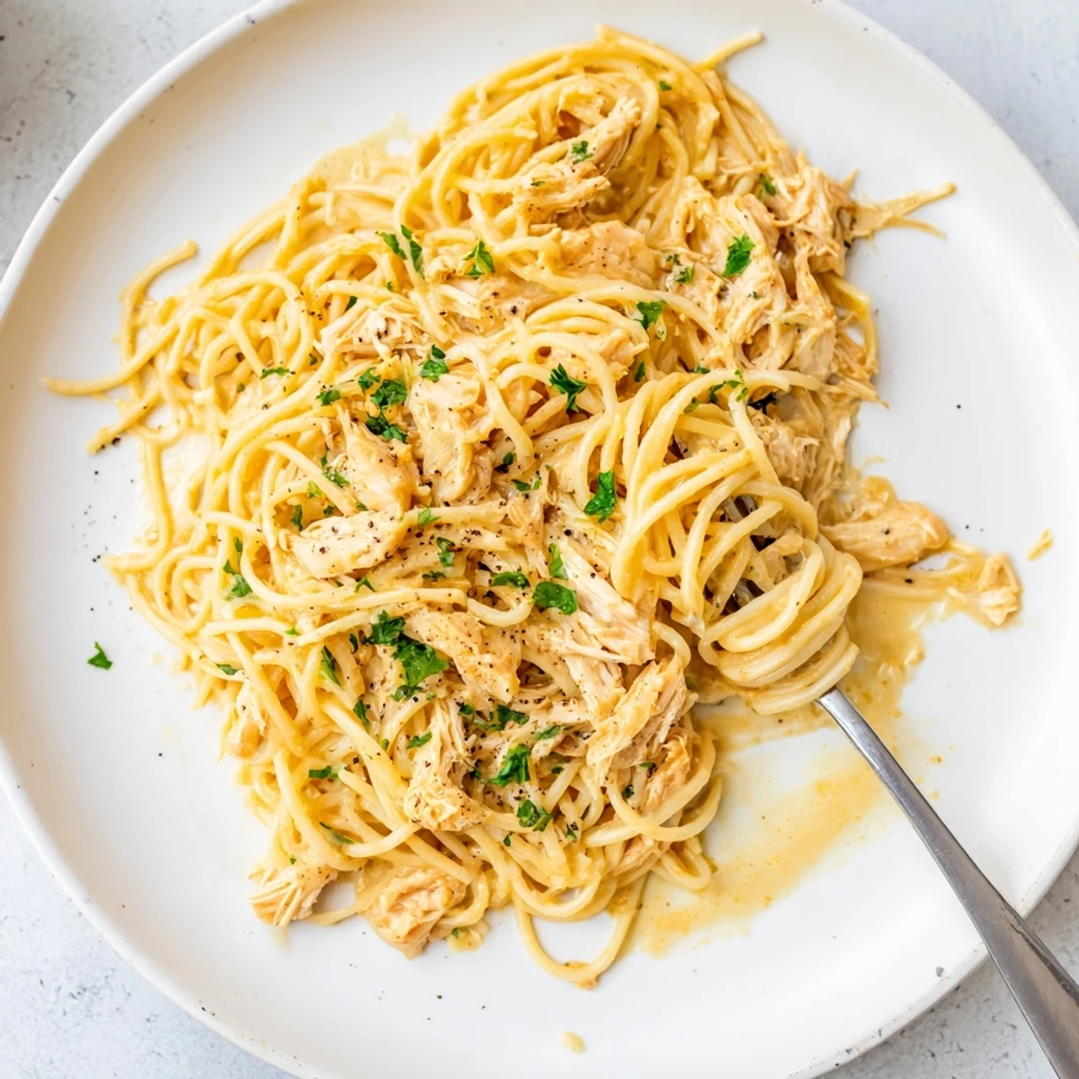 Creamy Crock Pot Angel Chicken served over tender angel hair pasta with golden sauce