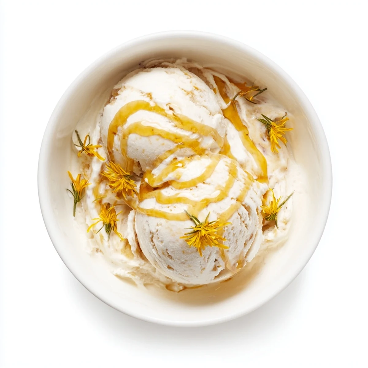 Velvety homemade dandelion honey ice cream topped with fresh edible dandelion flowers