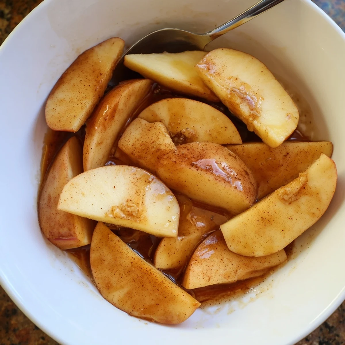 Golden Instant Pot cinnamon apples swimming in a rich, spiced brown sugar syrup