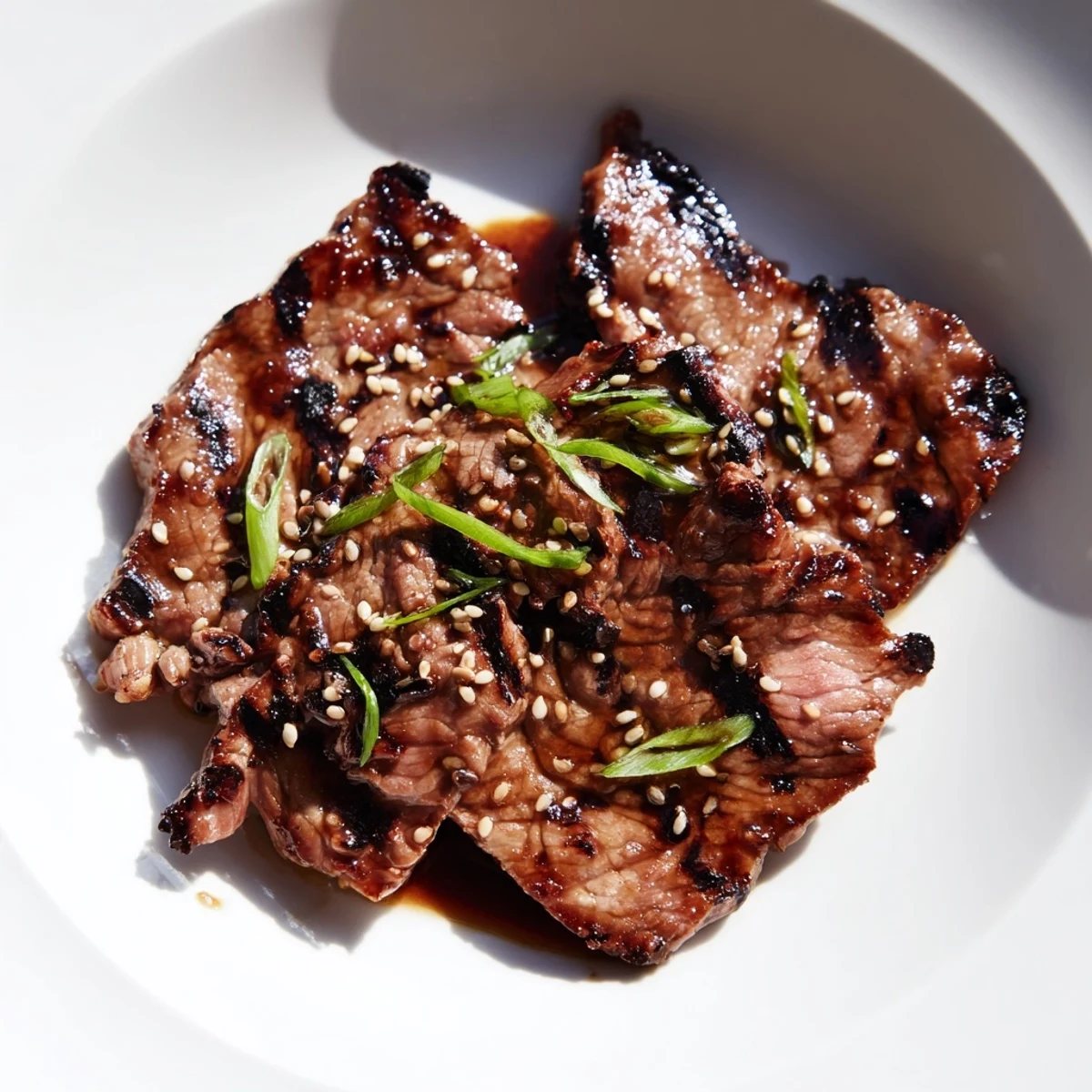 Sizzling Beef Yakiniku with caramelized edges served alongside charred colorful vegetables