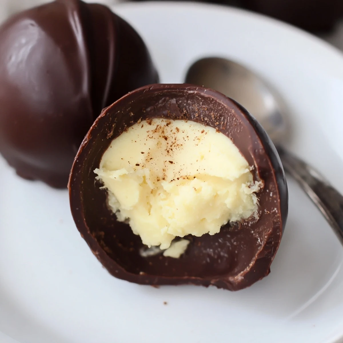 Dark Chocolate Eggnog Truffles with glossy shells and creamy spiced centers