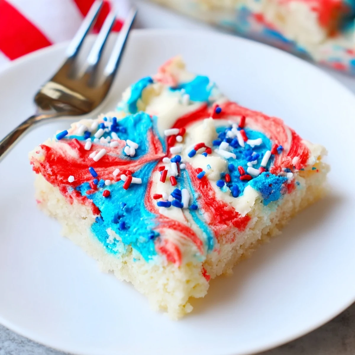 Slice of Patriotic Sugar Cookie Bars on a plate, buttery and festive