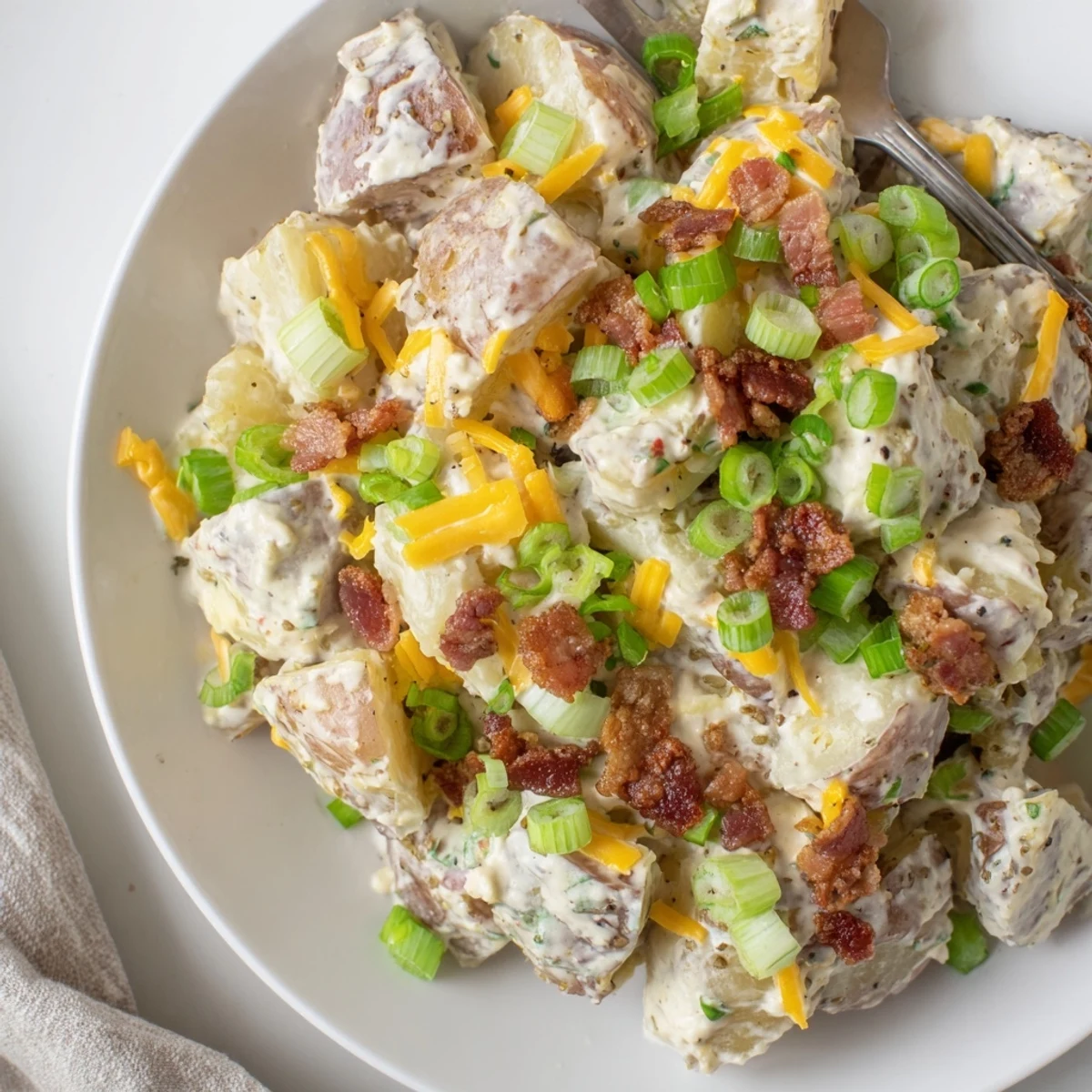 Beef Bacon Loaded Potato Salad piled high, creamy dressing and crispy bacon