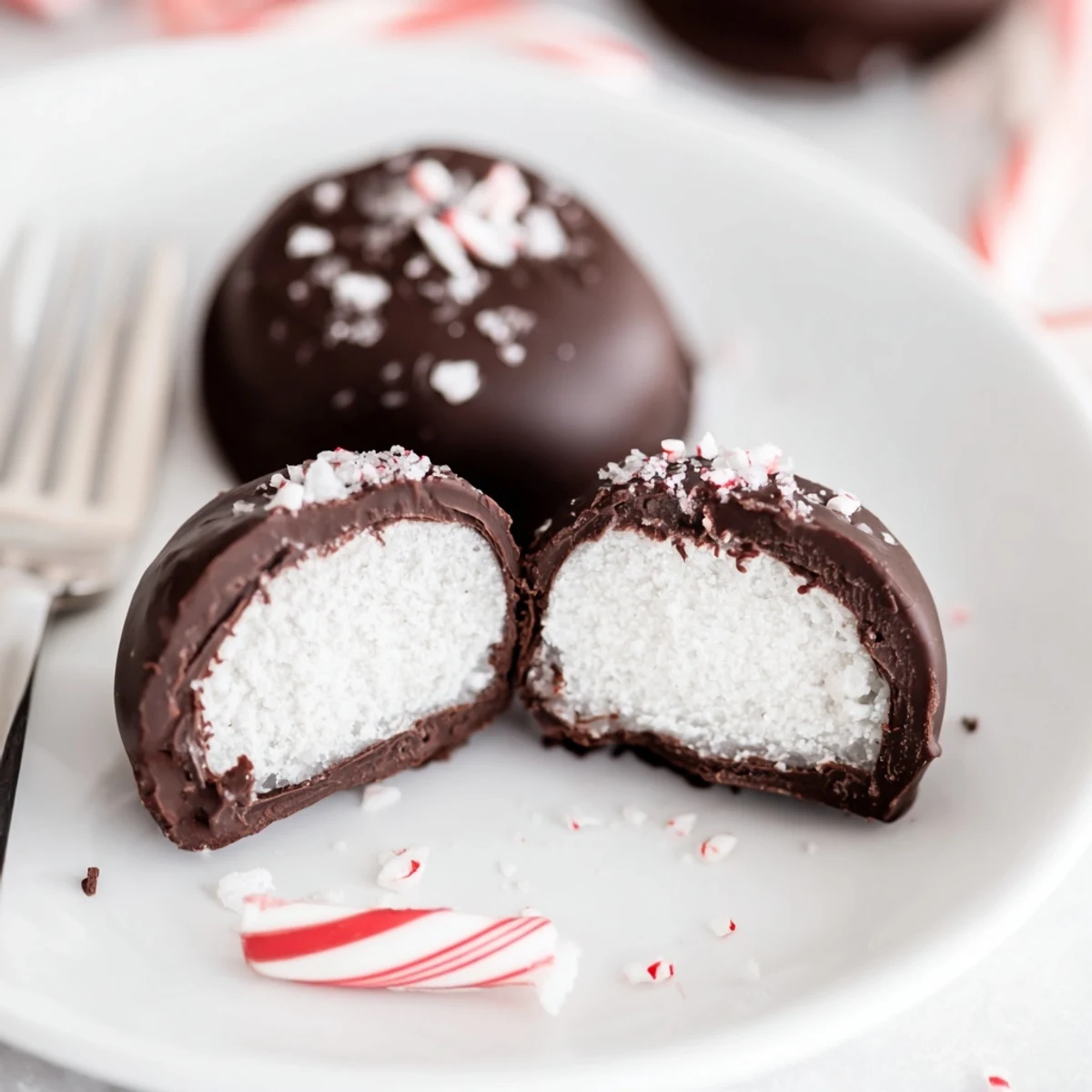 Homemade Peppermint Patties chilled on a baking sheet, speckled candy garnish