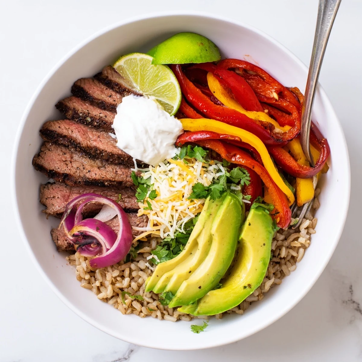 Steak Fajita Power Bowls with sizzling steak, charred peppers, creamy avocado slices