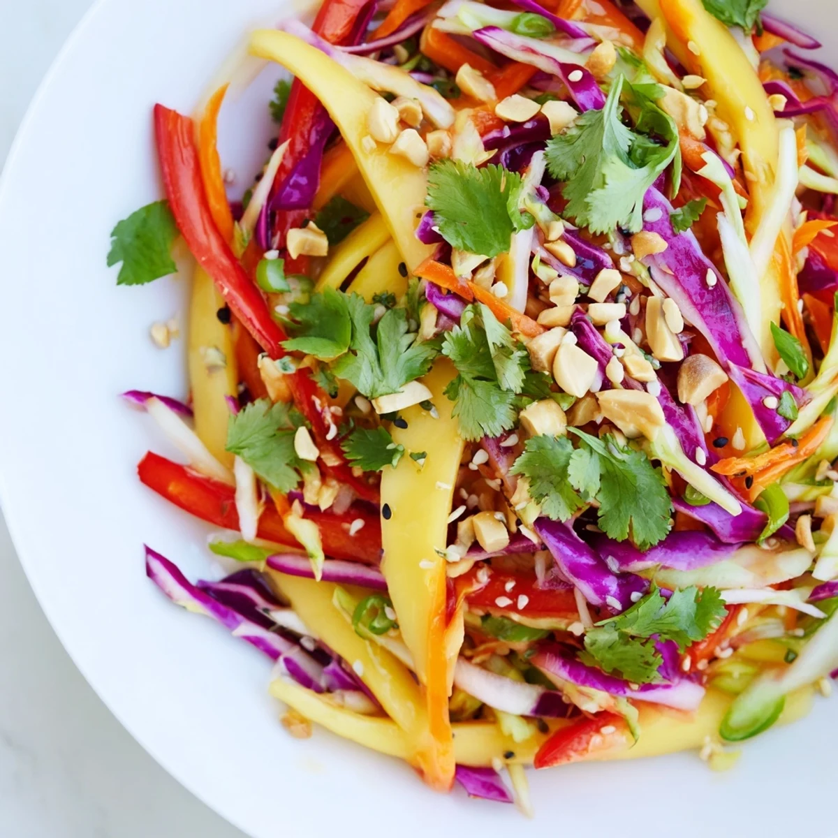 Summer ready refreshing mango slaw with juicy mango strips and tangy lime vinaigrette