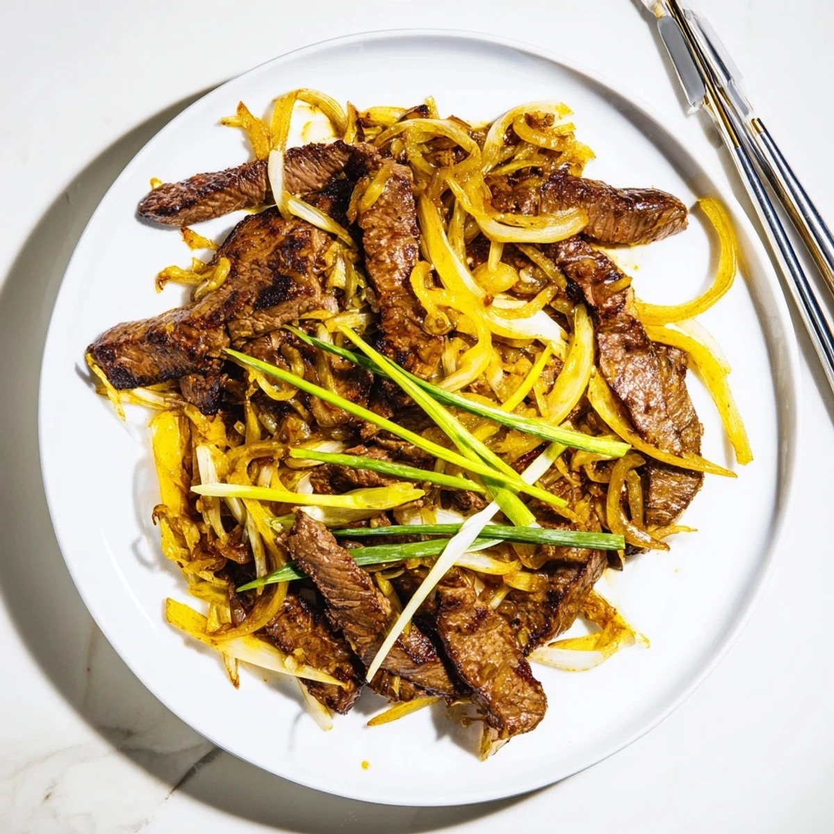 Close-up of tender seared flank steak and onions garnished with fresh green spring onions