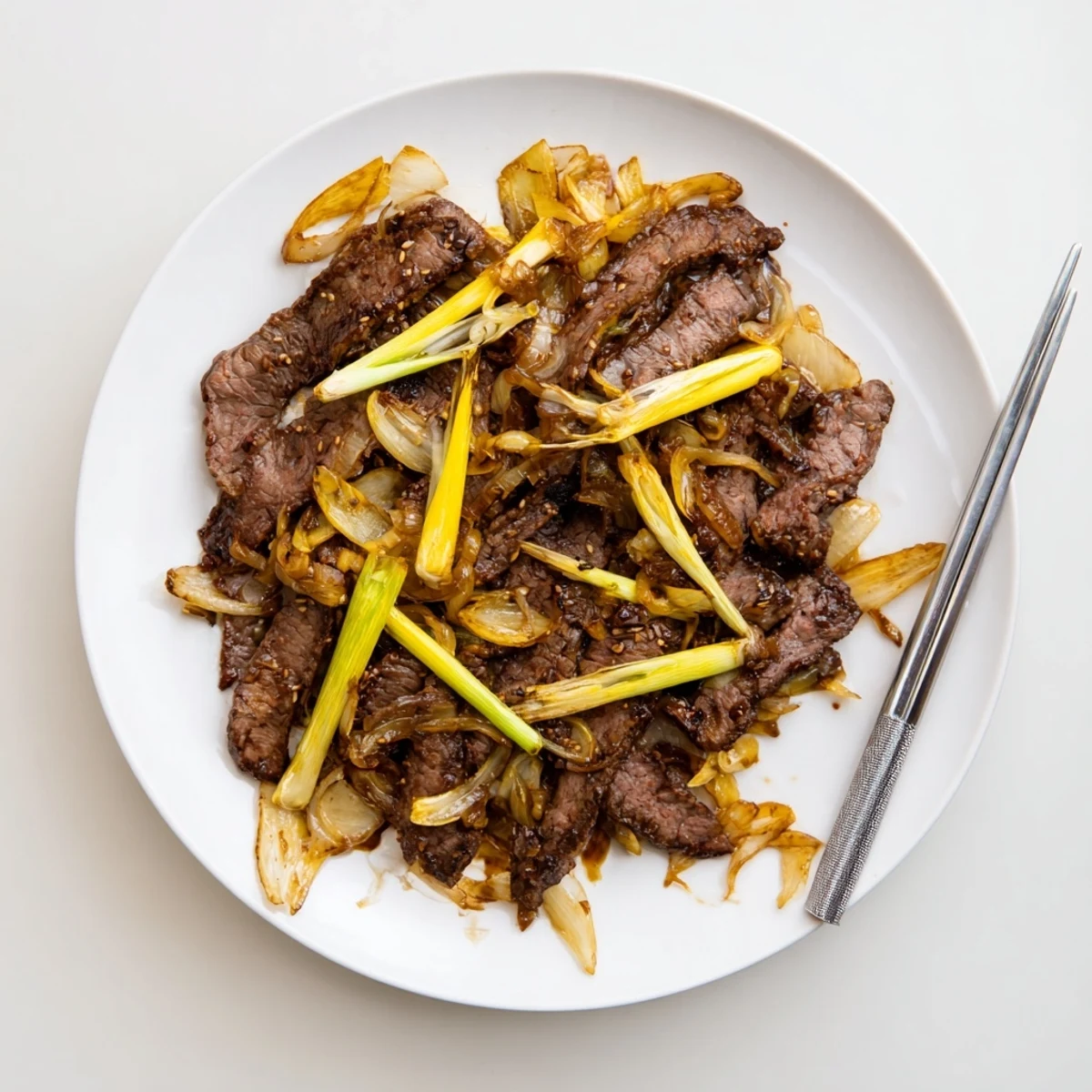 Golden crispy beef strips tossed with sweet caramelized onions in a savory dark sauce