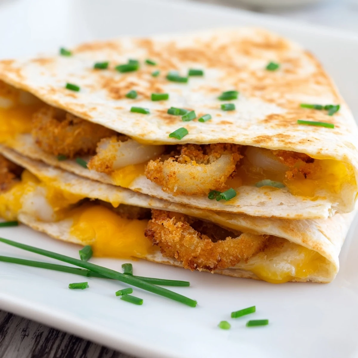 Tex-Mex quesadillas stuffed with battered onion rings and shredded cheese blend