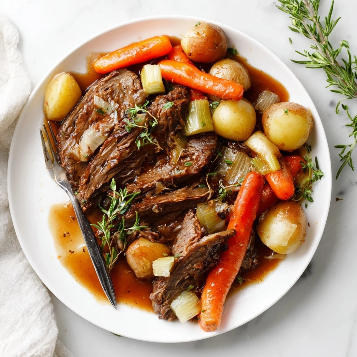 Slow cooked herb braised beef chuck roast with meltingly tender meat and fresh thyme