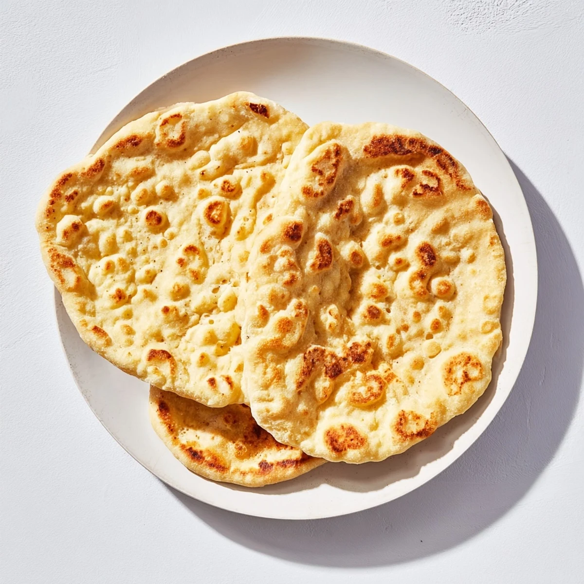 Golden Turkish Bazlama flatbread with soft pillowy texture and charred spots served warm