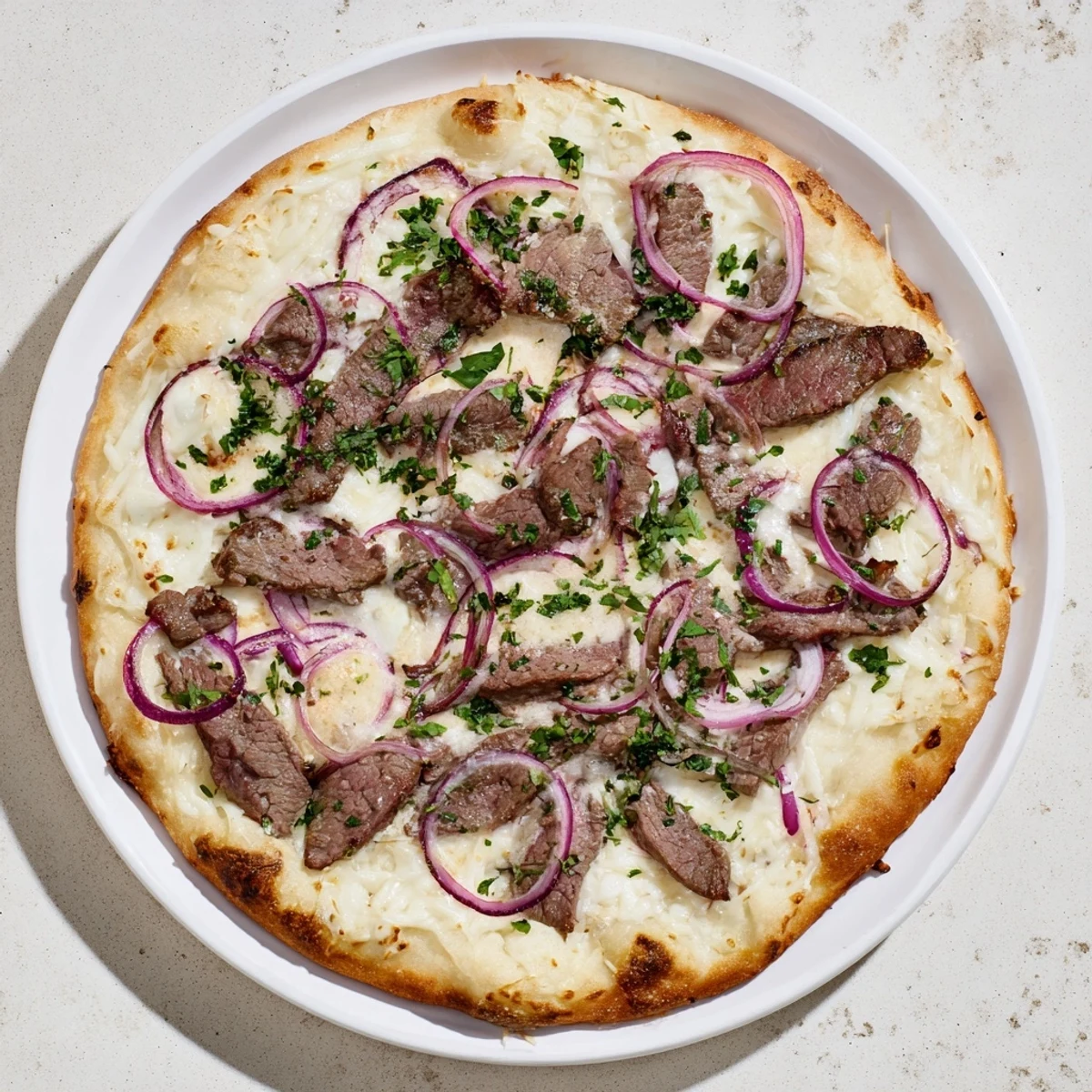 Golden beef alfredo pizza bubbling with melted mozzarella and provolone cheese on a crispy crust