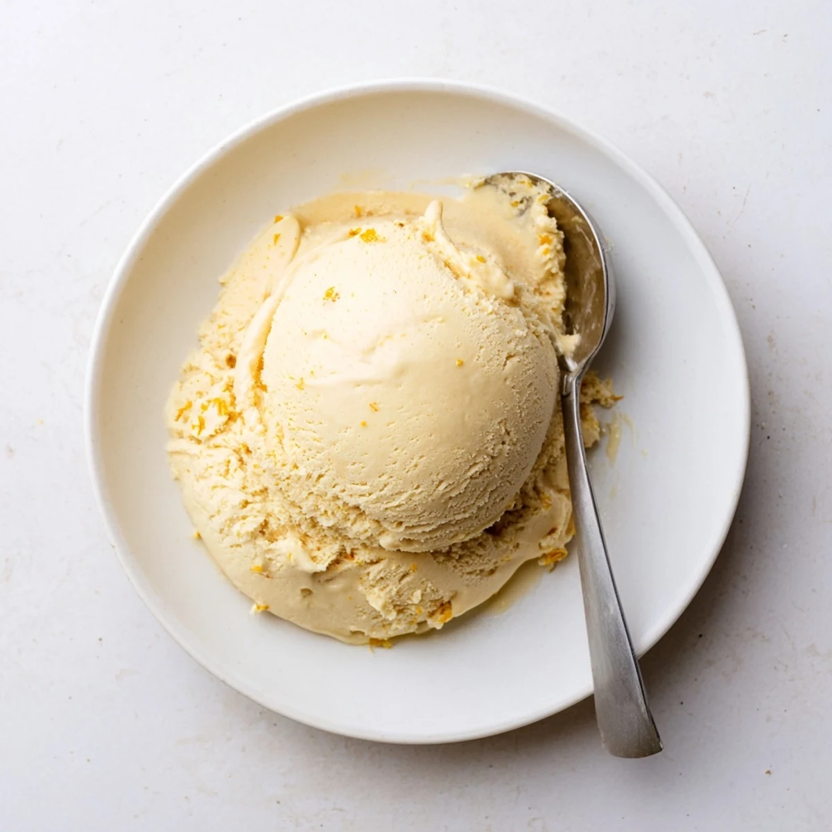 Velvety dandelion honey ice cream served with fresh blossoms for a bright spring dessert