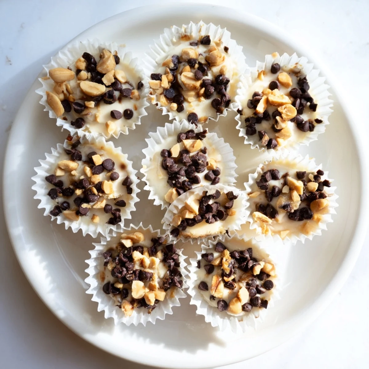 Golden high protein frozen peanut butter Greek yogurt bites topped with melted chocolate chips
