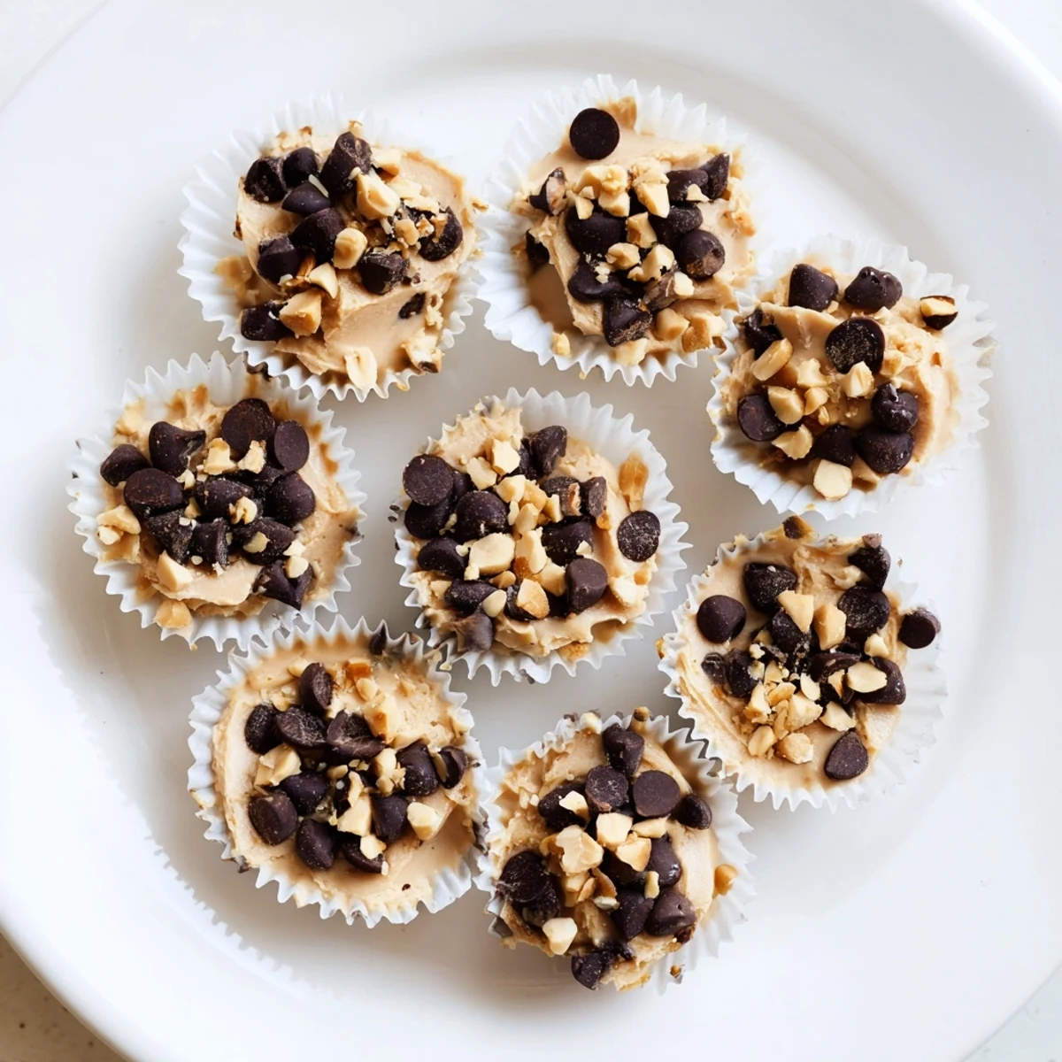 Creamy frozen peanut butter Greek yogurt bites arranged in a mini muffin tin