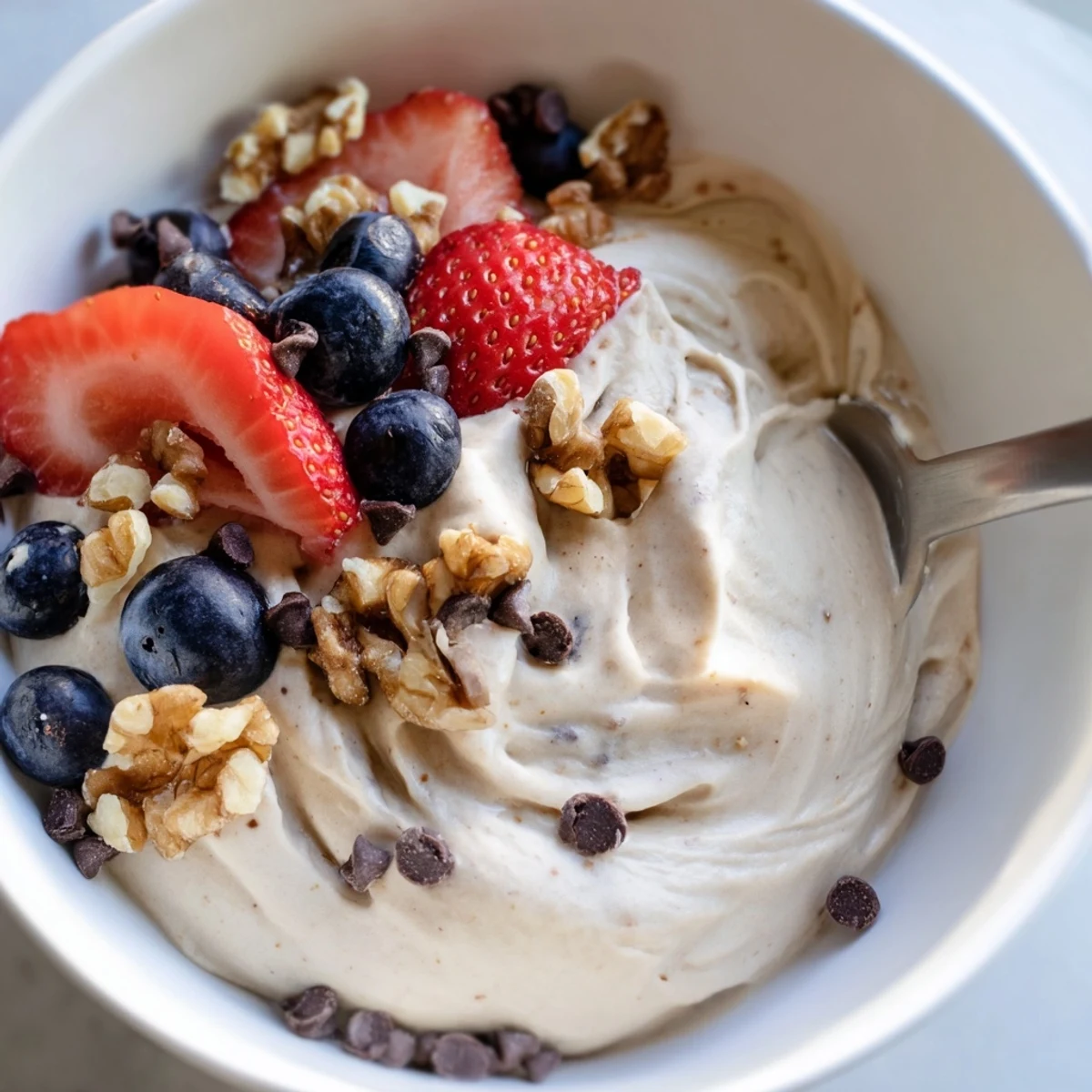 Dairy-free banana nice cream recipe displaying smooth soft-serve texture in chilled glass serving bowls