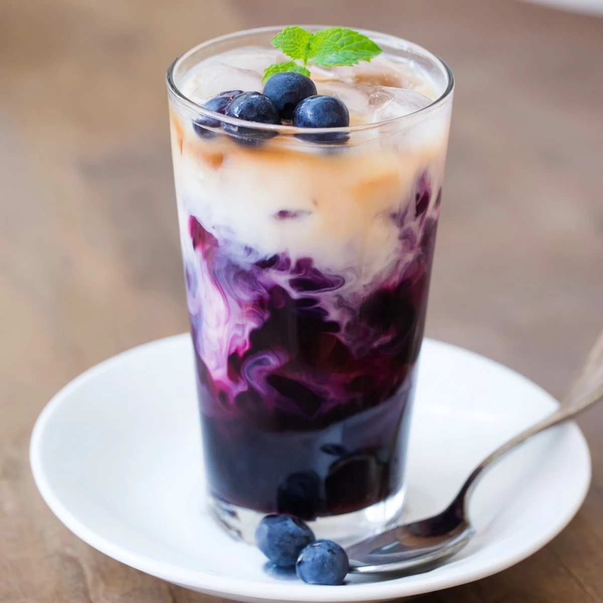 Chilled Blueberry Milk Tea Cooler with fresh blueberries and mint garnish
