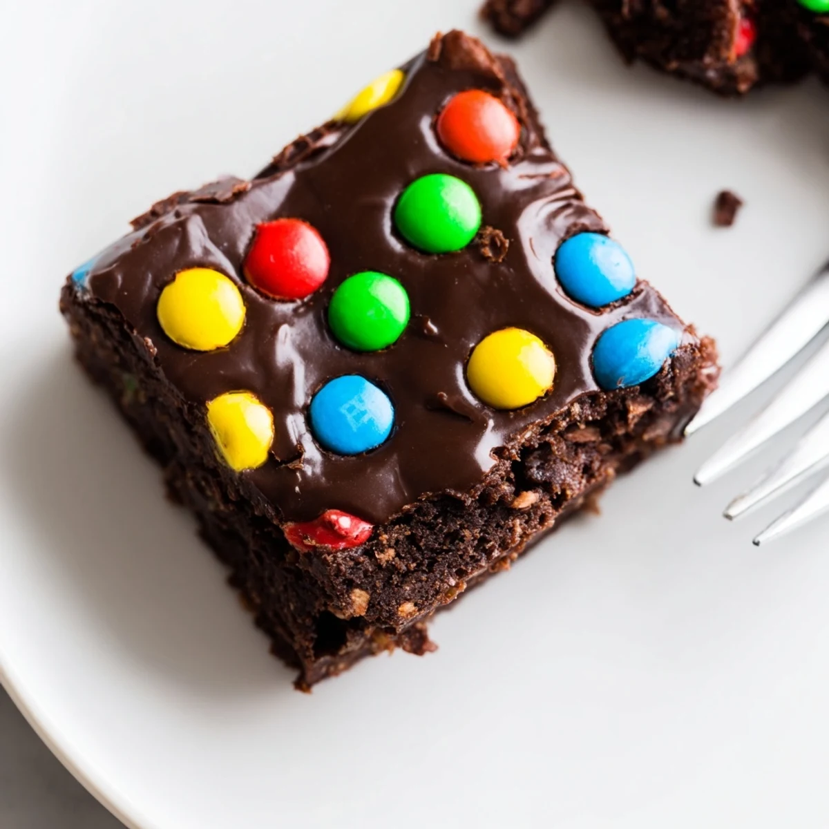 Plated Gourmet Cosmic Brownies Bars next to a chilled glass of milk.