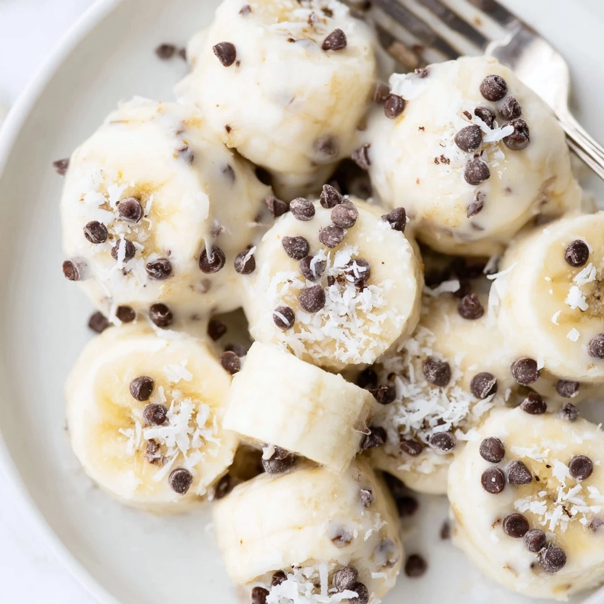 Tray of Frozen Banana Yogurt Bites garnished with shredded coconut, ready to serve
