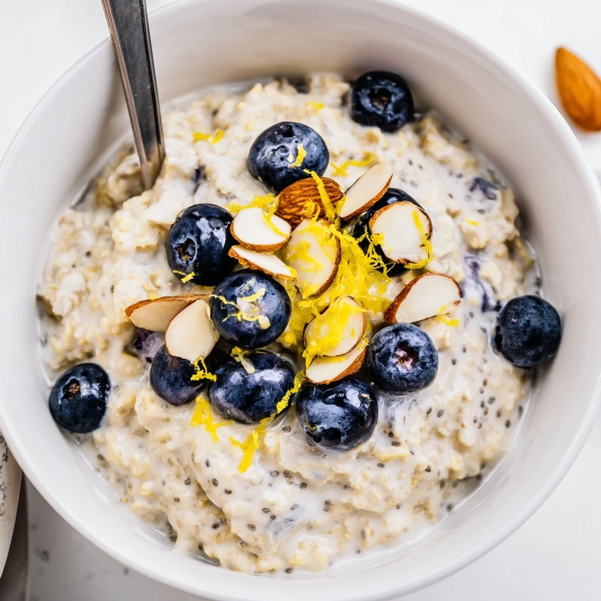 Creamy Blueberry Lemon Overnight Oats topped with extra blueberries and lemon zest