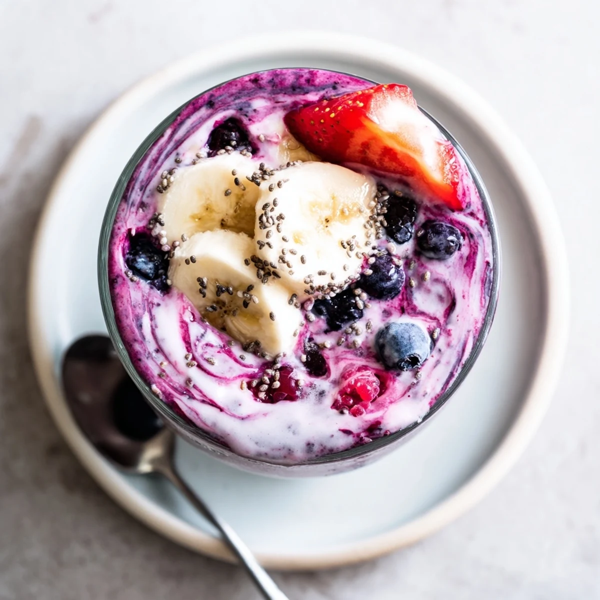 Chilled Summer Berry Smoothie with banana and almond milk, topped with berries
