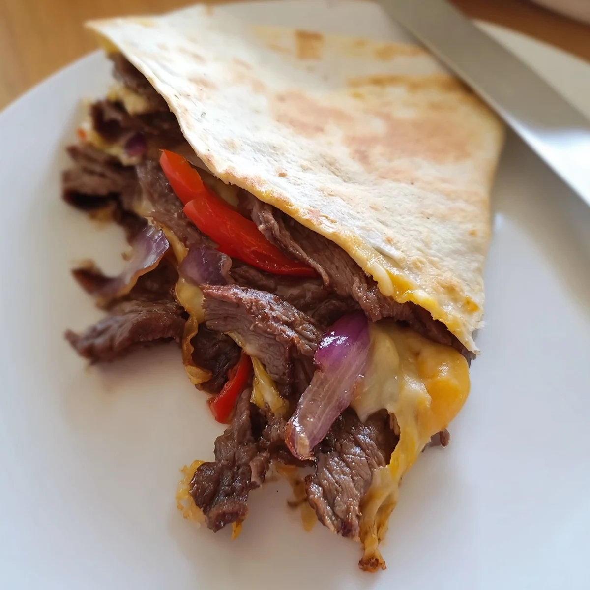 Sweet Savory Beef Quesadillas with melty cheese, crisp tortillas, lime wedge.