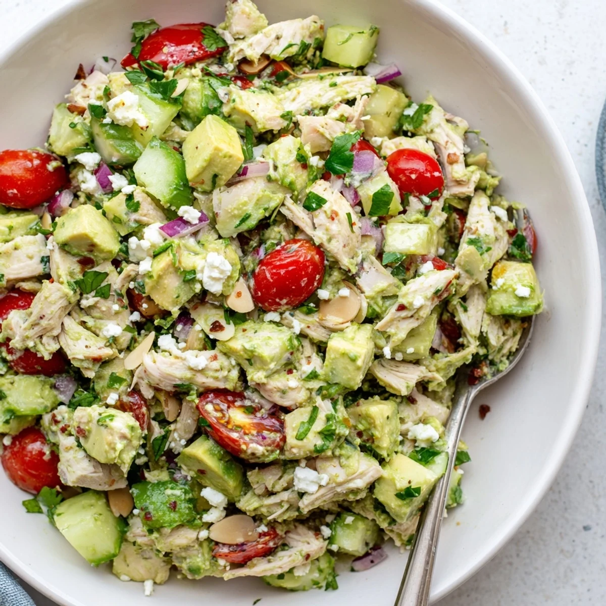 Avocado Chicken Salad piled in a bowl, tender chicken, zesty lime dressing  