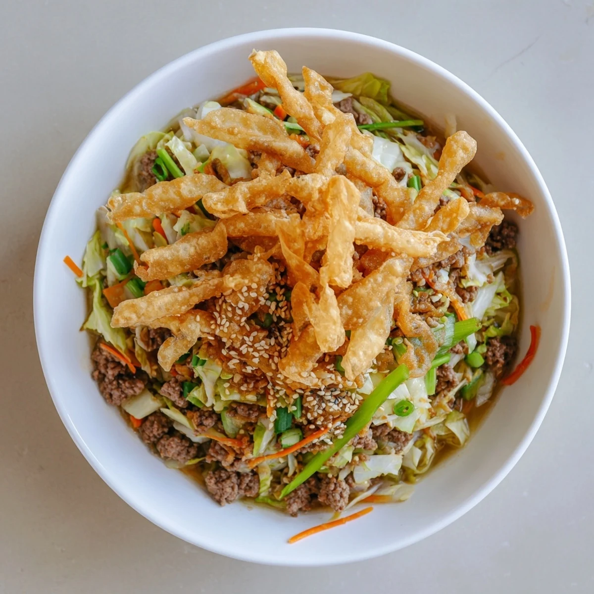 Comforting beef egg roll soup delight with colorful shredded cabbage, carrots, and savory broth garnished with crispy golden egg roll croutons