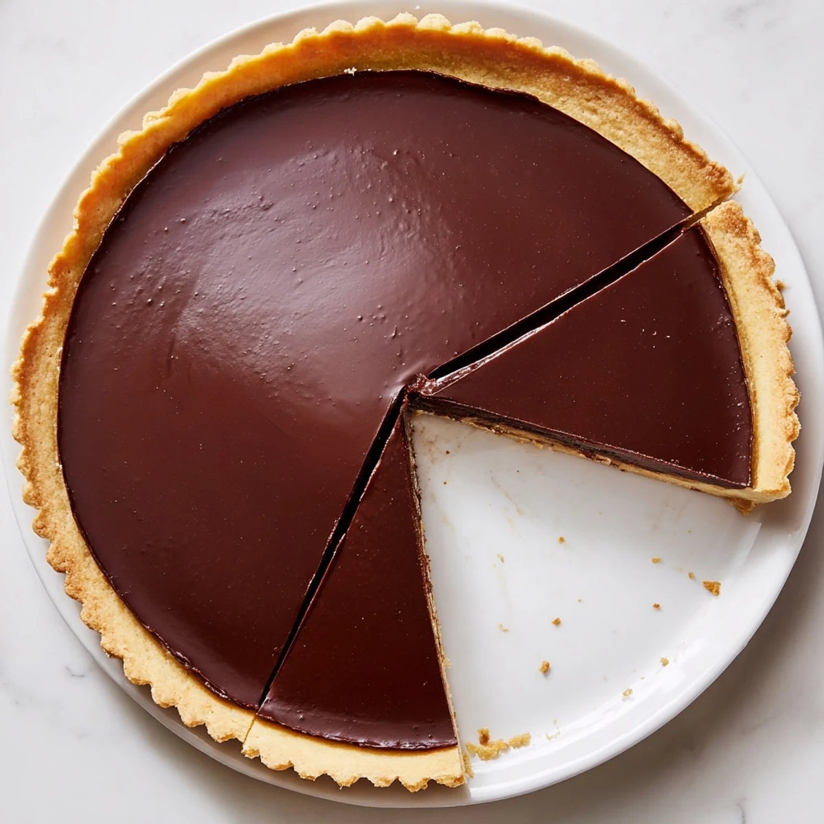 Sliced wedge of French Chocolate Flan revealing the rich silky chocolate custard layered inside a delicate baked pastry shell