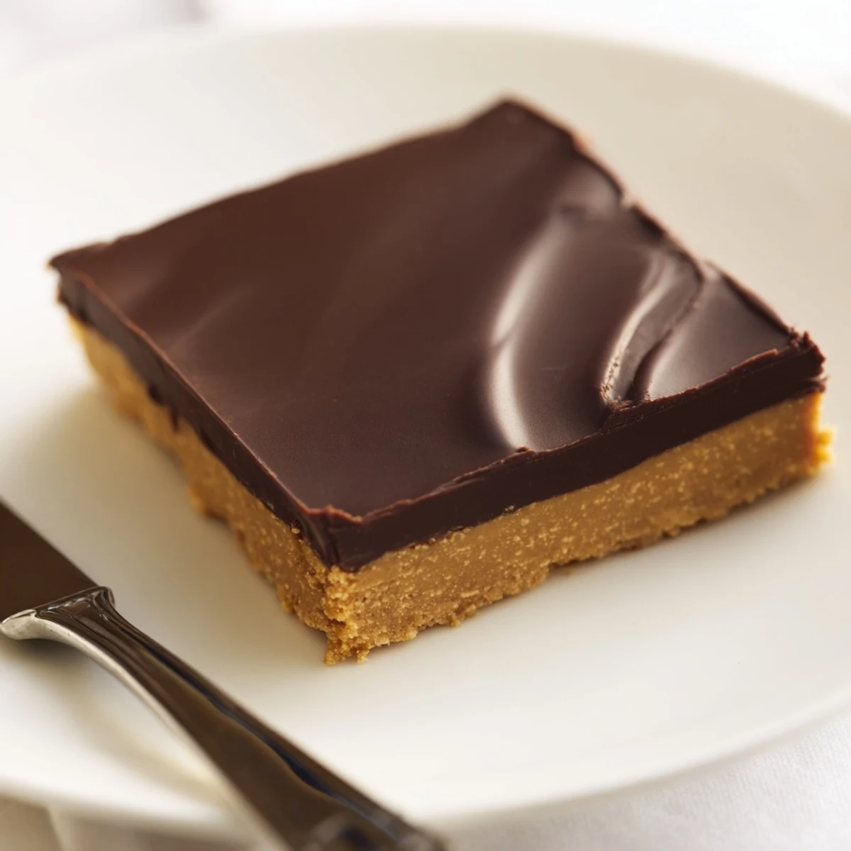 Square peanut butter bars cut into neat pieces showcasing creamy peanut butter and rich chocolate topping
