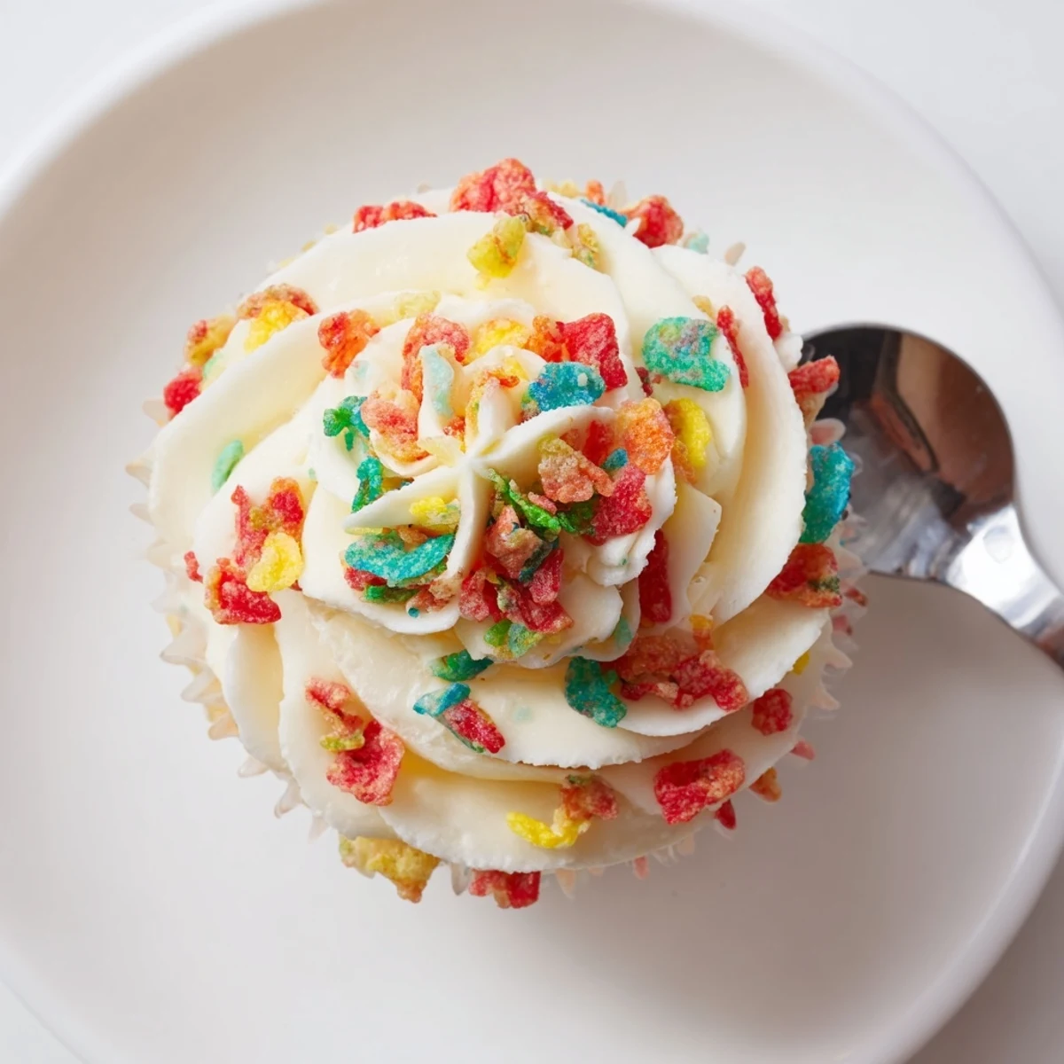 Bright Fruity Pebbles Cereal Frosting topping vanilla cake, crunchy colorful bites