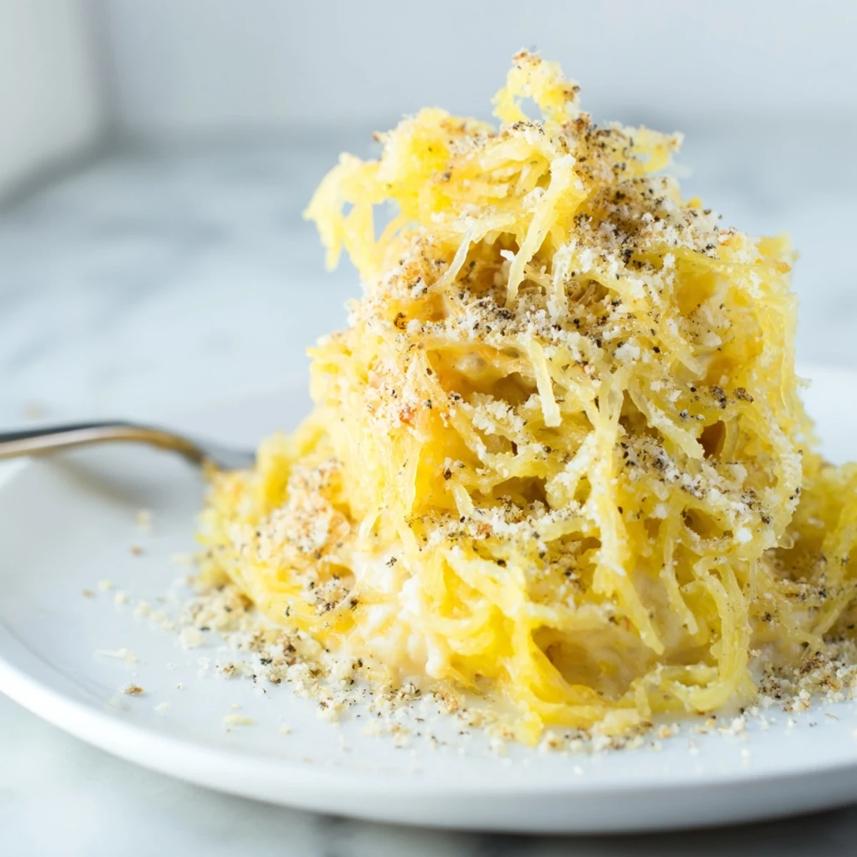 Creamy Spaghetti Squash Mac Cheese in a baking dish, golden breadcrumb topping.