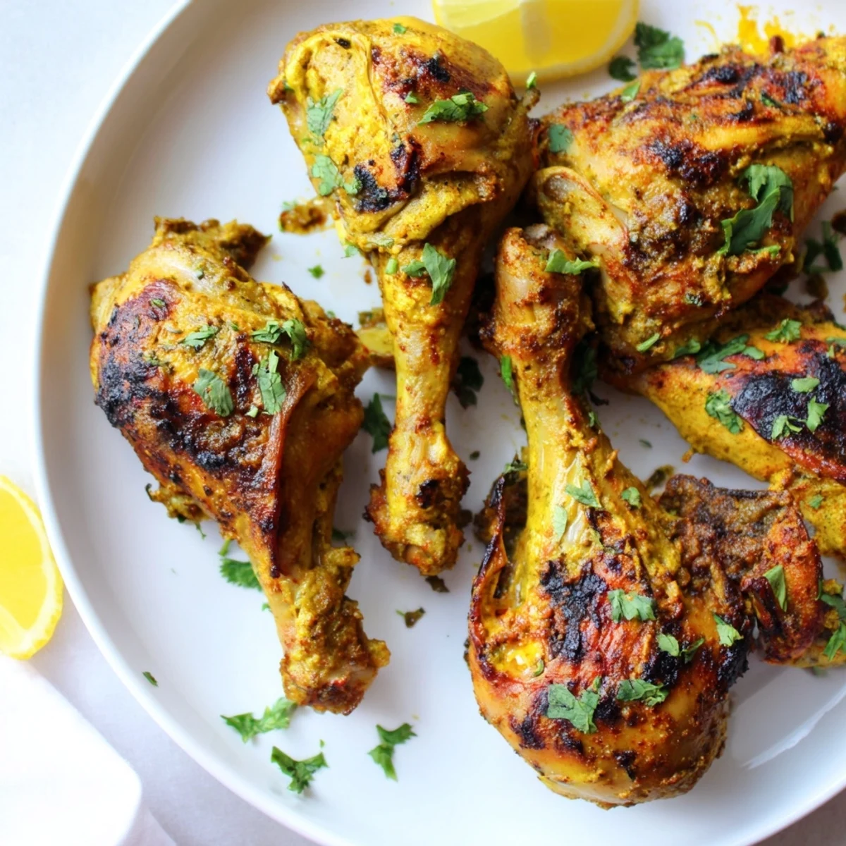 Juicy Tandoori Chicken resting on a cutting board, garnished with cilantro sprigs