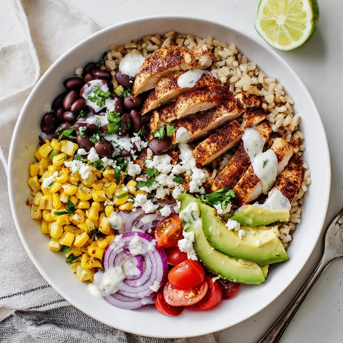 Healthy street corn chicken bowl with charred corn, creamy sauce, and fresh cilantro