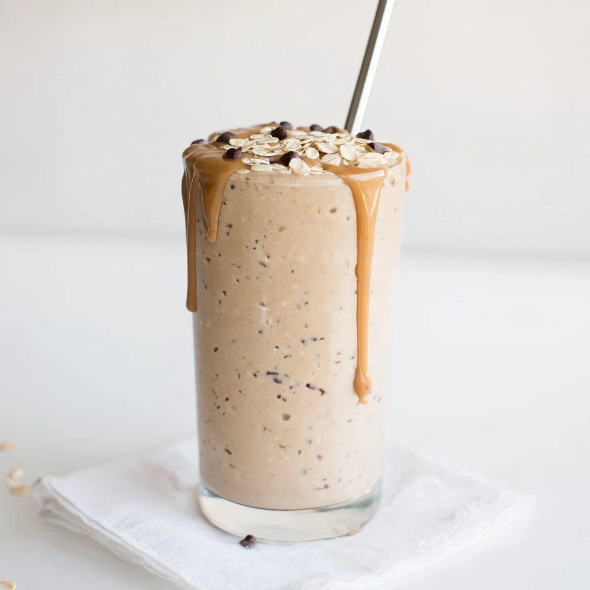 Creamy oatmeal cookie dough protein smoothie swirled with cinnamon and almond butter