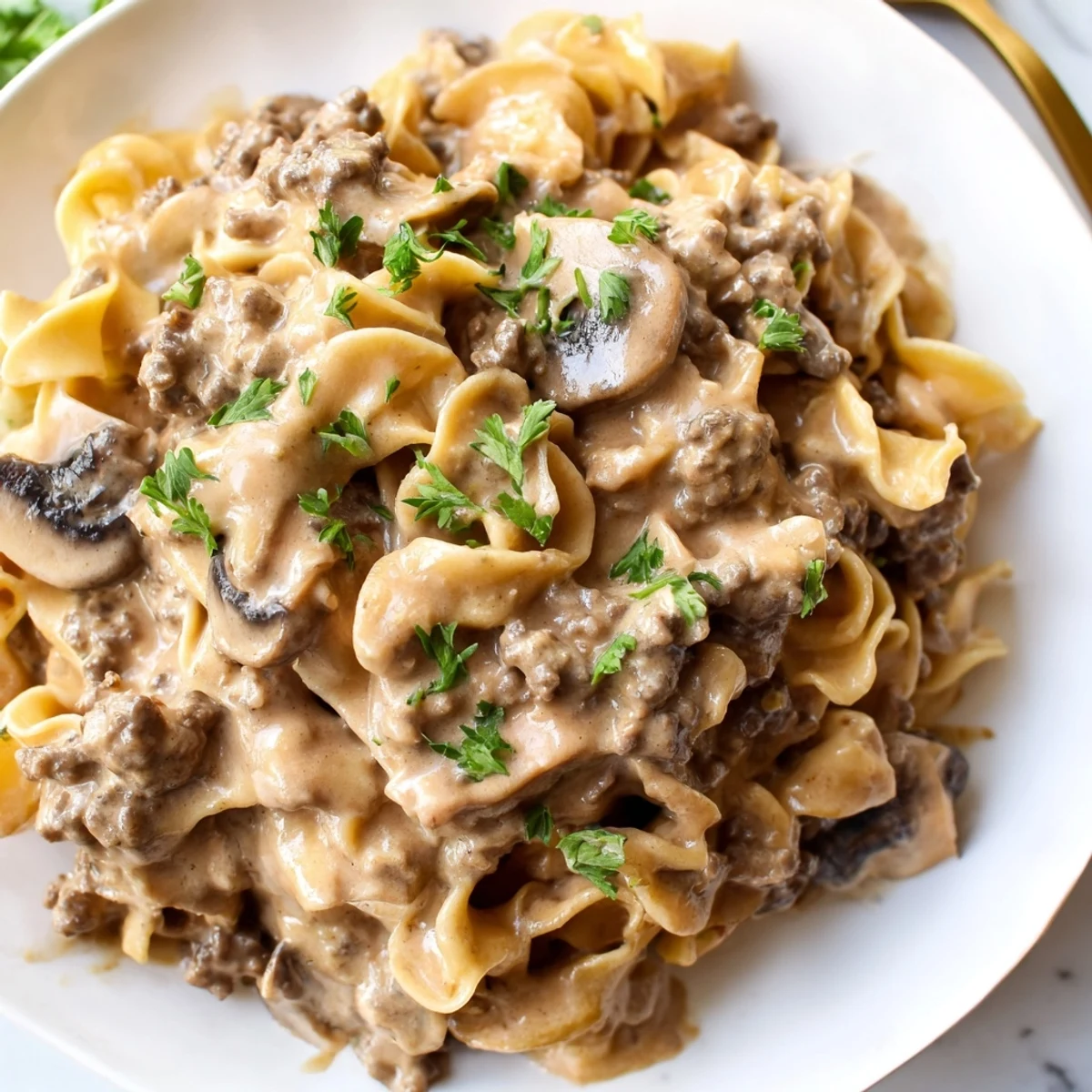 Golden brown ground beef and mushroom stroganoff in a rich velvety sauce