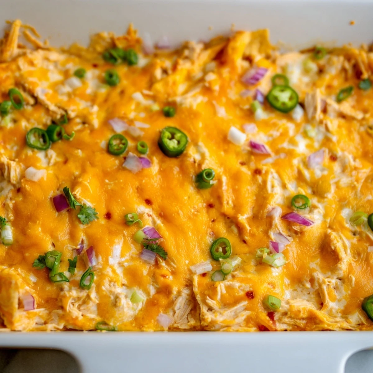 Golden bubbling jalapeno buffalo chicken casserole fresh from the oven with melted cheese