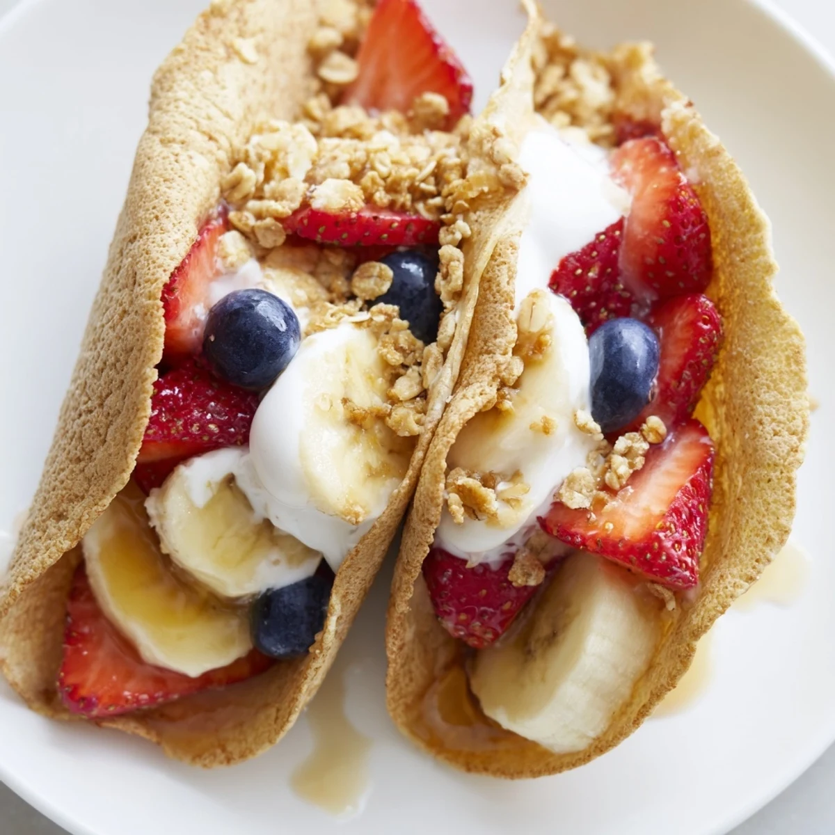 Soft pancake tacos stuffed with scrambled eggs and crumbled bacon on plate