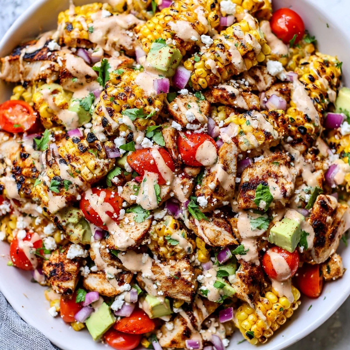 High Protein Chicken Street Corn Salad topped with crumbled cotija and fresh cilantro