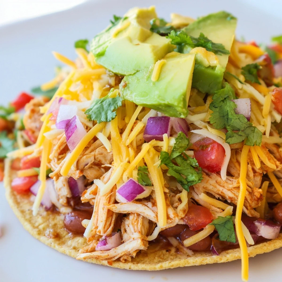 Crispy corn tortillas piled high with seasoned chicken for savory Chicken Tostadas.  