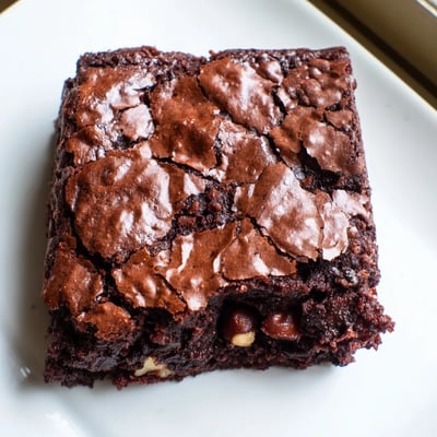 Warm ultimate brownies served with a scoop of vanilla ice cream on top